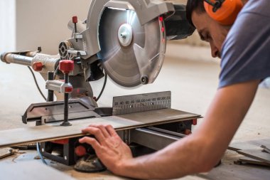a man working with a miter saw clipart