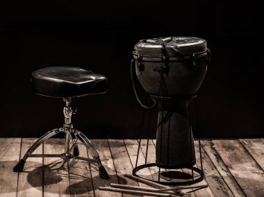 musical percussion instruments on black background clipart