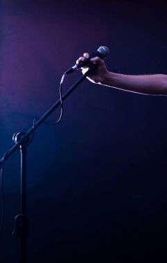 Sahne Alanı'nda el siyah bir arka plan güzel müzik konsepti üzerinde mikrofon ile aydınlatma