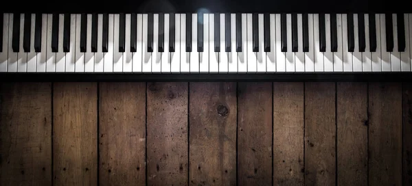 Piano on wooden background closeup — Stock Photo, Image