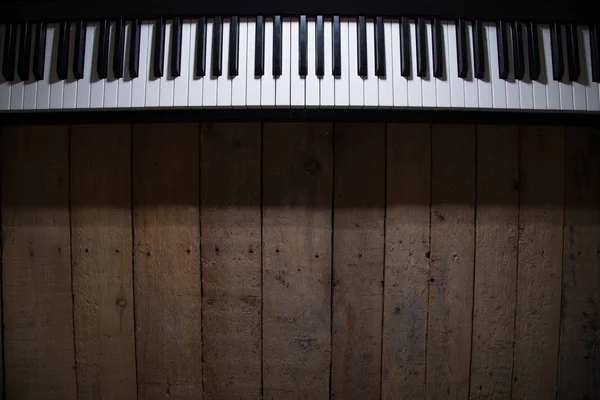 Piano on wooden background closeup — Stock Photo, Image