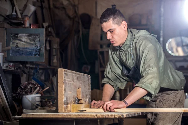 Мужчина работает на машине с деревянным изделием — стоковое фото