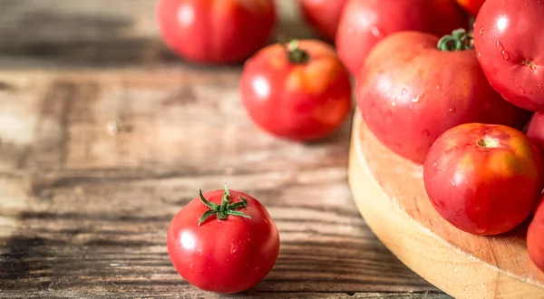 Ripe Tomatoes on wooden background — Stock Photo, Image