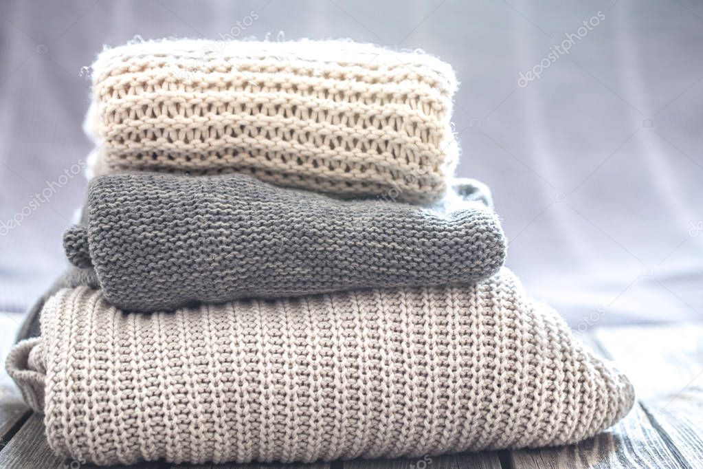 beautiful knitted clothes, neatly folded, close-up, handmade swe