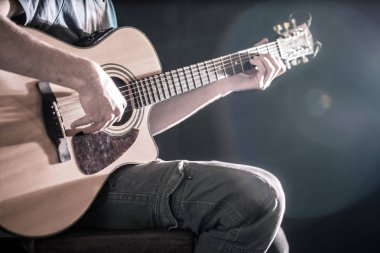 the hand of man playing acoustic guitar, close-up, flash of ligh clipart