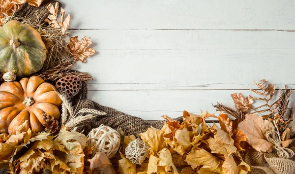 Autumn background with decorative items and pumpkin.