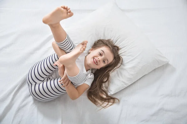 Cute little girl in bed woke up in the morning . — Stock Photo, Image