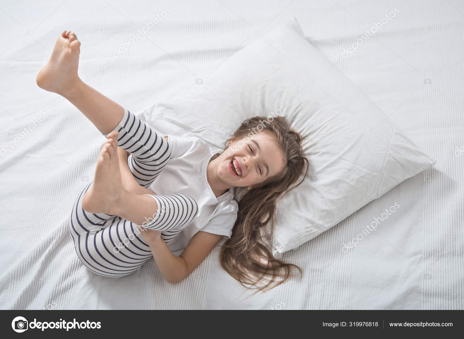 Cute little girl in bed woke up in the morning . Stock Photo by ...