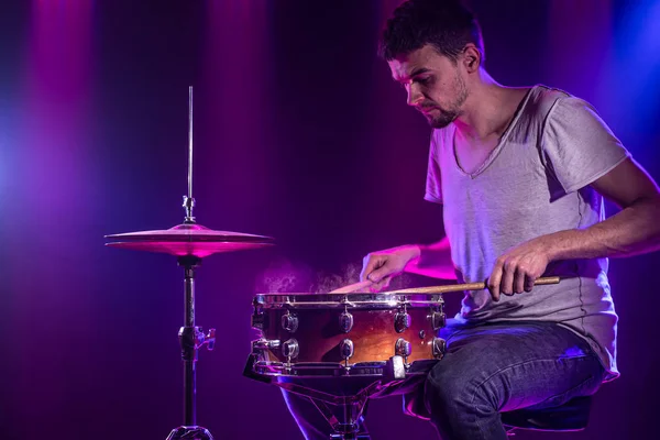 O baterista toca bateria. Belo fundo azul e vermelho , — Fotografia de Stock