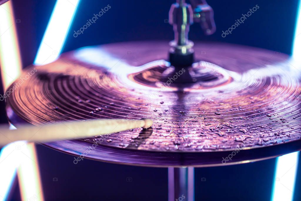 Hi-hat close-up of plates with drumsticks