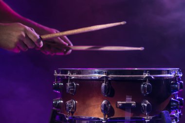 The drummer plays the drums. Beautiful blue and red background,  clipart