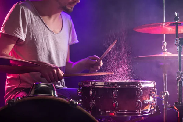 The drummer plays the drums. Beautiful blue and red background, — Stockfoto