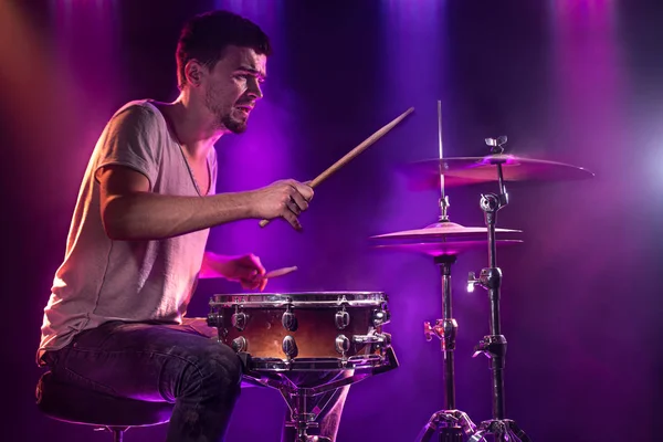 O baterista toca bateria. Belo fundo azul e vermelho , — Fotografia de Stock