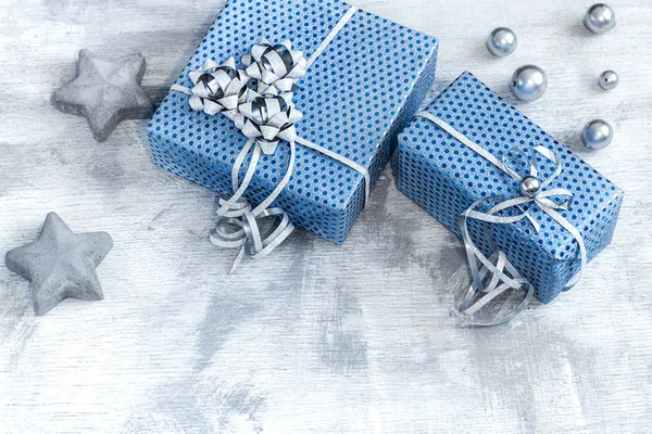 Blue gift box on a light wooden background. — ストック写真