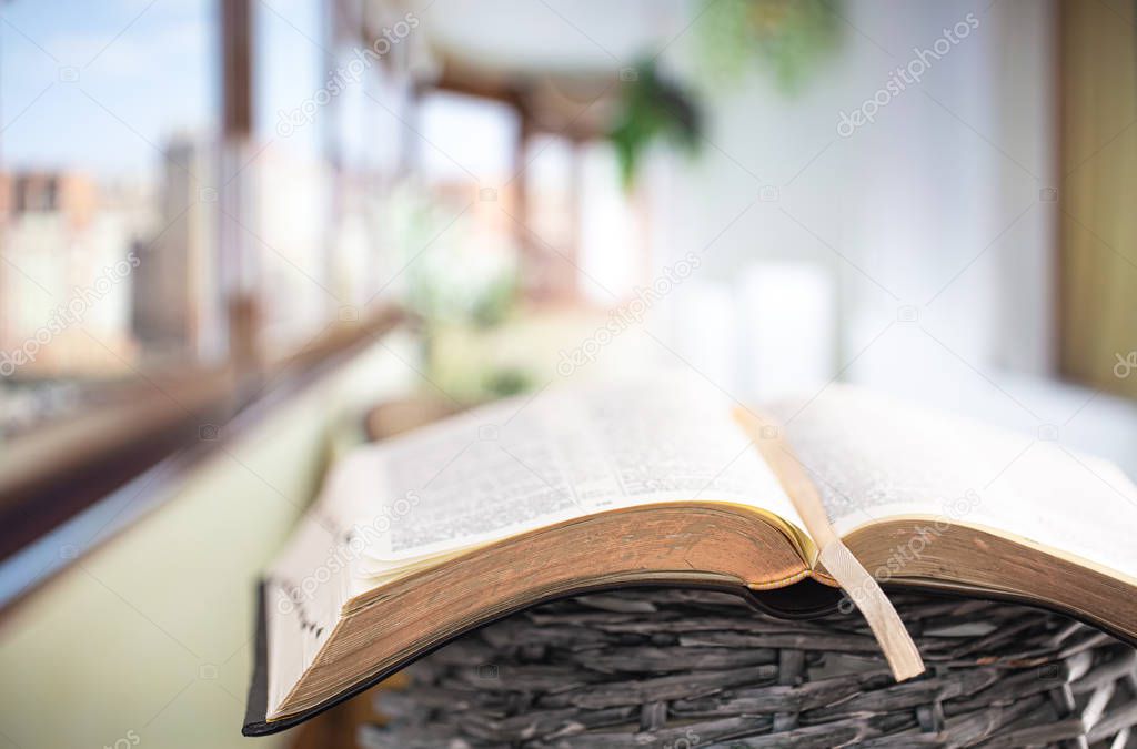Book Bible close-up, on a beautiful terrace background. Morning 