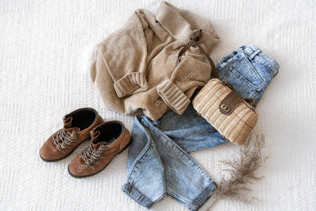 Set with fashionable women's clothing jeans and a sweater .