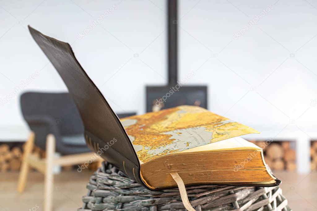 Open book Bible, on the background of the living room with a fir