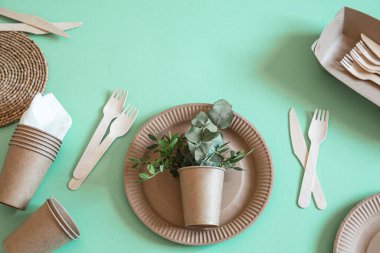 Çevre dostu, şık geri dönüşümlü kağıt sofra takımı. Nane ve mavi arka planda kağıt yiyecek kutuları, tabaklar ve mısır nişastası. .