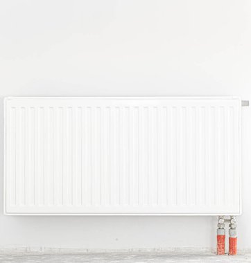Beyaz bir duvarın önündeki radyatör. Ön manzara. Metin için boşluk.