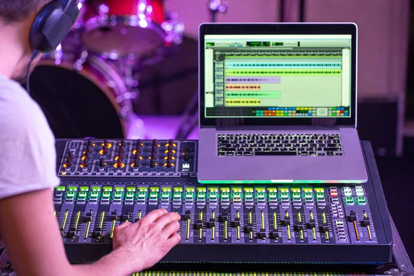 Digital mixer in a recording Studio , with a computer for recording music. On the background of the sound engineer at work. The concept of creativity and show business.