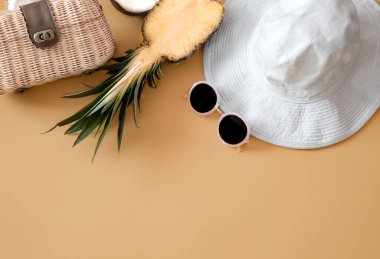 Renkli kadın moda kıyafeti düz katlı. Kadın şapkası, güneş gözlüğü, çanta ve taze ananas. Yaz modası ya da tatil gezisi konsepti
