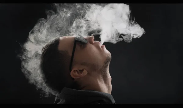 Vaper exhaling cloud of steam