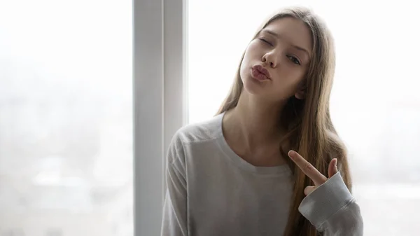 Attractive Teenager Winking Looking Camera While Sitting Window — Stock Photo, Image