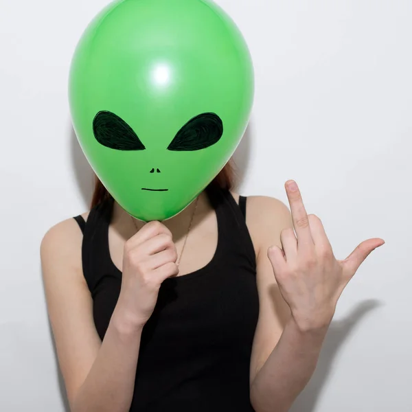 Girl Holding Green Balloon Alien Face Showing Middle Finger — Stock Photo, Image