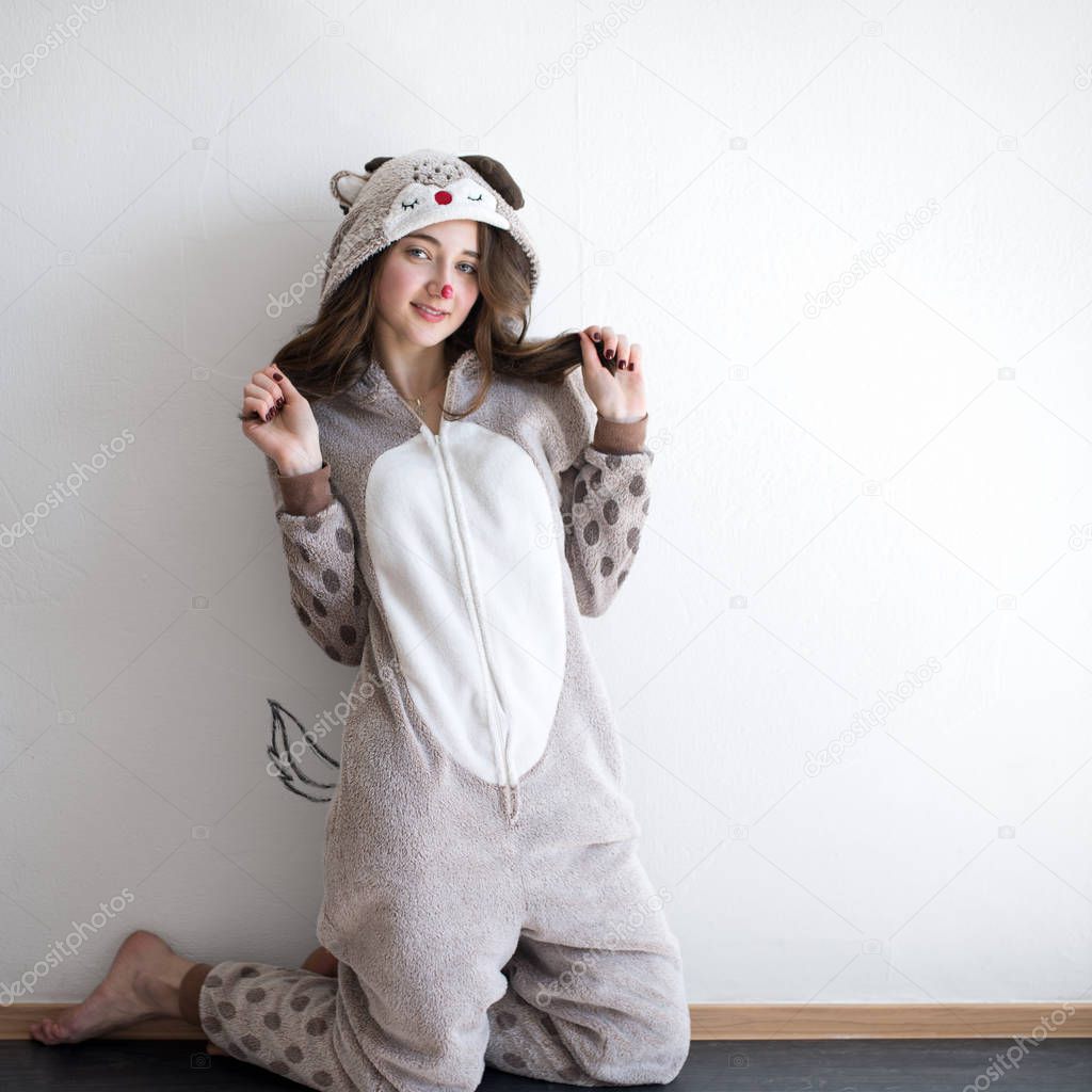 cute teenage girl dressed in a kigurumi costume posing