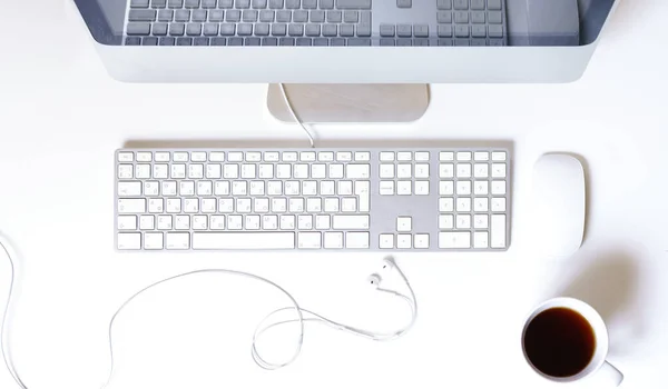 White table with the office equipments, computer keyboard and other office supplies, flat lay, top view. Working in a home office concep