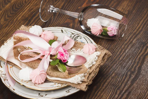 Rosas de color rosa claro y vajilla en la mesa de madera —  Fotos de Stock