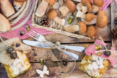 Çiğ beyaz mantar, çam kozalakları ahşap masa üzerinde kuru süslemeleri ile