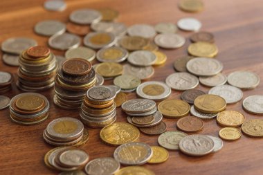 Farklı altın ve gümüş collector's sikkeleri üzerinde ahşap masa