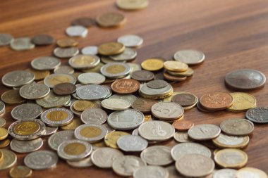 Farklı altın ve gümüş collector's sikkeleri üzerinde ahşap masa