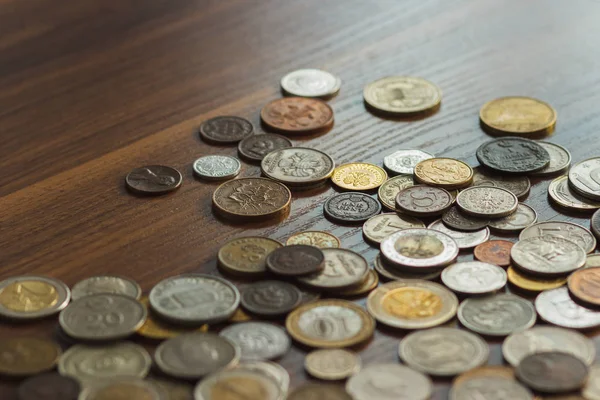 Different old collector's coins with a magnifying glass, blurred background  Stock Photo by ©lisssbetha@gmail.com 302688454