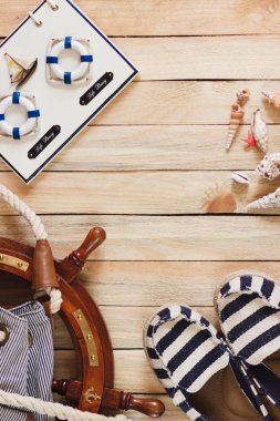 Çizgili terlik, çanta ve deniz süslemeleri, ahşap arka plan