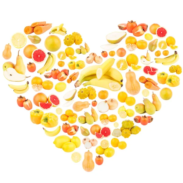 Verschiedene gelbe und orangefarbene Früchte und Gemüse in Herzform — Stockfoto