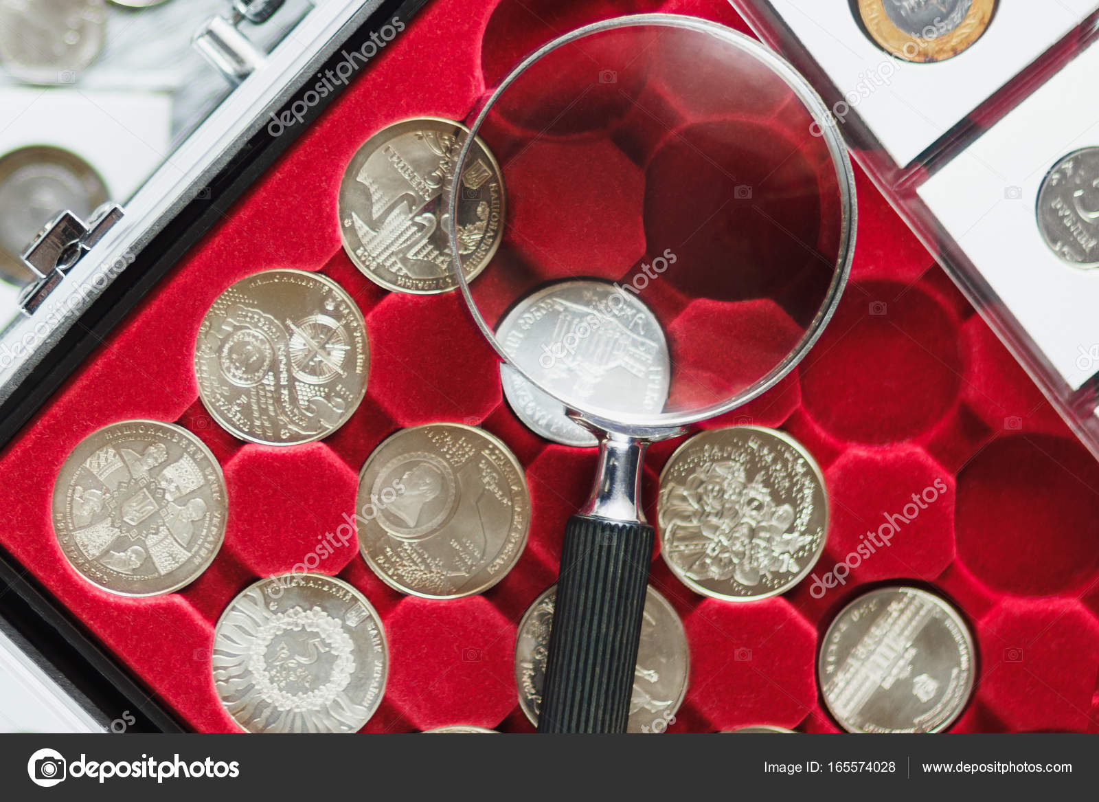 Different old collector's coins with a magnifying glass, blurred background  Stock Photo by ©lisssbetha@gmail.com 302688454