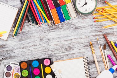 Ahşap arka plan üzerinde farklı okul malzemeleri