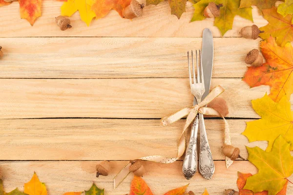 Cutlery in the frame made from maple leaves — Stok Foto