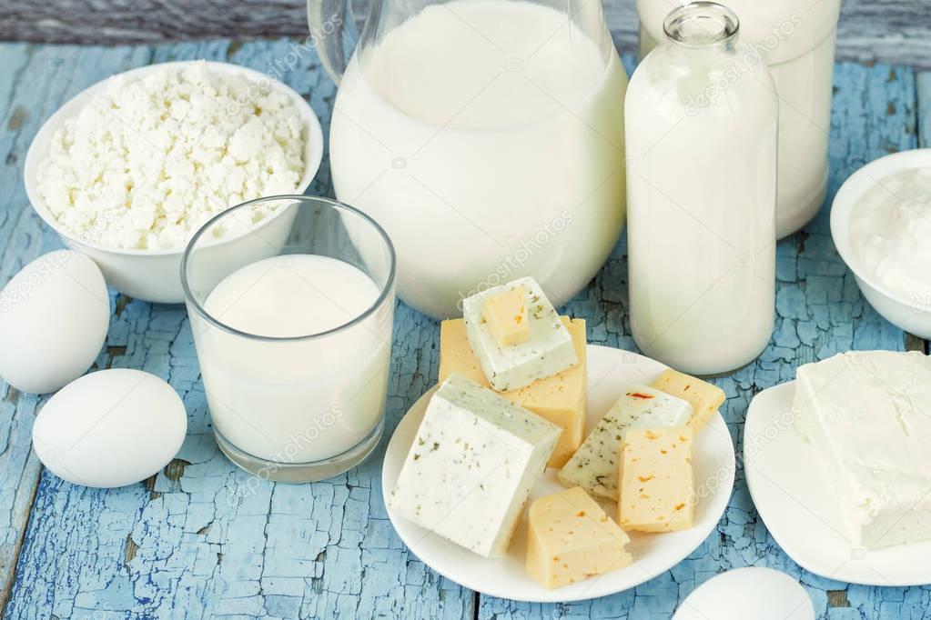 Set of different milk products on the wooden background