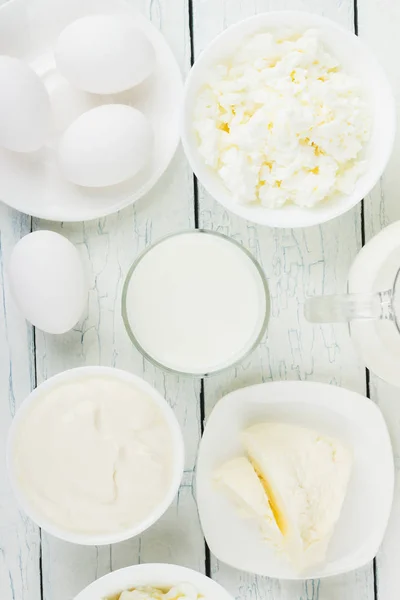 Different dairy products, white wooden background — Stock Photo, Image