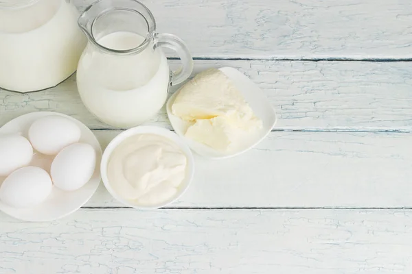 Different dairy products on the white wooden background — Stock Photo, Image