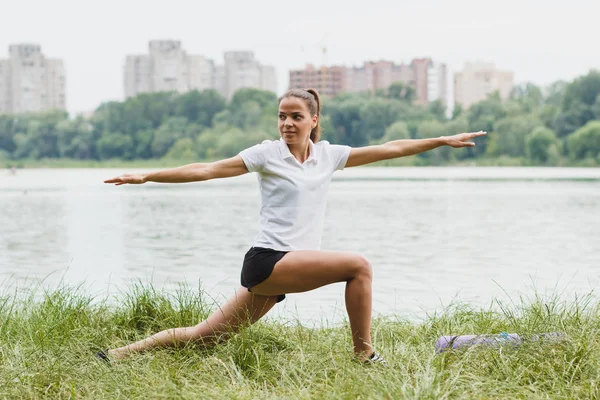 Sportovní atraktivní žena na pobřeží jezera sportovní cvičení — Stock fotografie