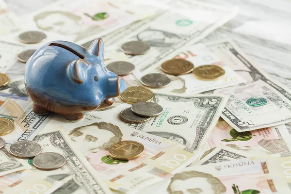 Ukrainian hryvnia, American dollars and a piggy bank — Stock Photo, Image