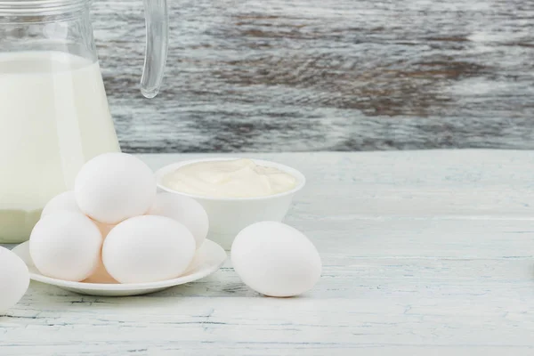 Different dairy products on the wooden background — Stock Photo, Image