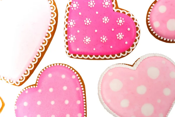 Fondo de galletas rosadas en forma de corazón con diferentes patrones, aislado — Foto de Stock