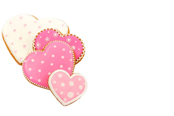 Pembe kurabiyelerin arka planında kalp farklı şekillerde, beyaz üzerine izole edilmiş. — Stok fotoğraf