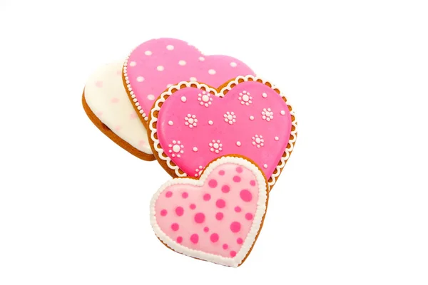 Fondo de galletas rosadas en forma de corazón con diferentes patrones, aislado — Foto de Stock