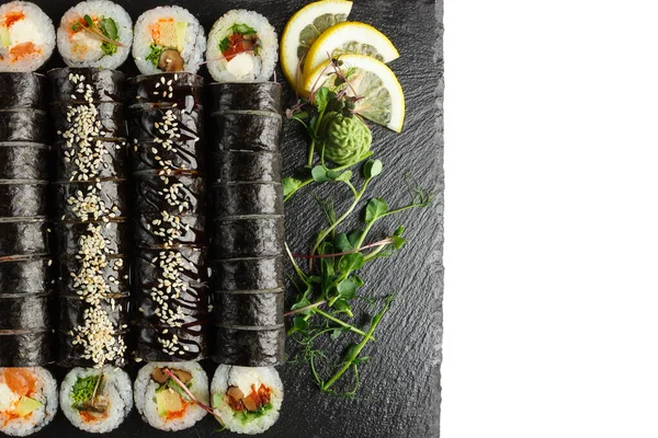 Japanese food: Set of salmon sushi and rolls with salmon and eel, top view